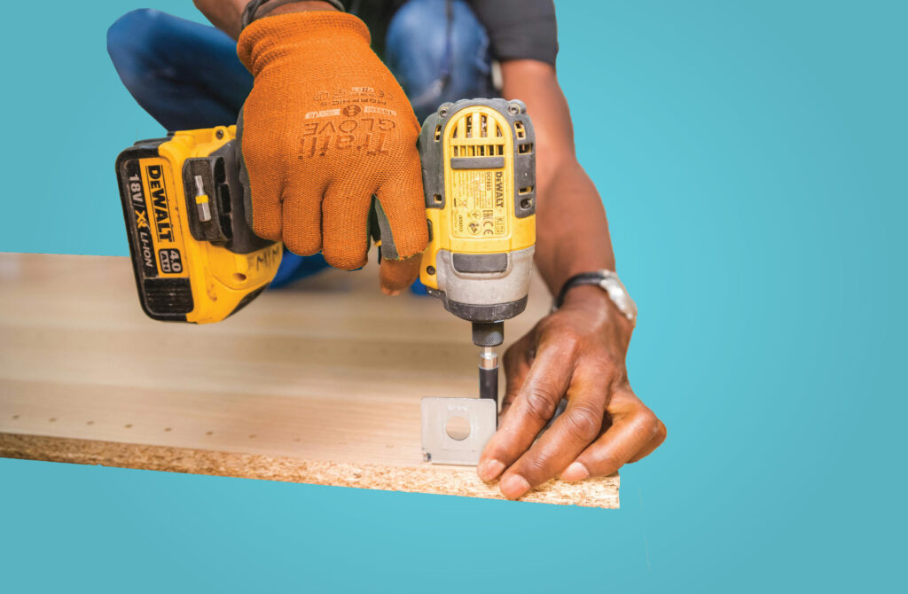 Picture of worker using a drill.